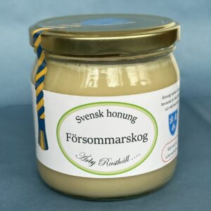 Glasburk med honung med namnet Försommarskog i en ljusgrön oval.